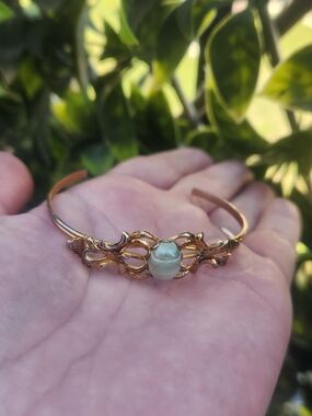Elegant Gold Tone Cuff Bracelet with Light Green Cabochon